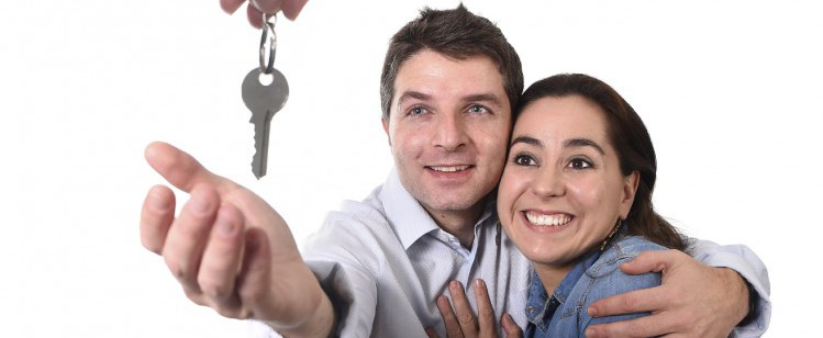 A picture of a couple receiving house keys