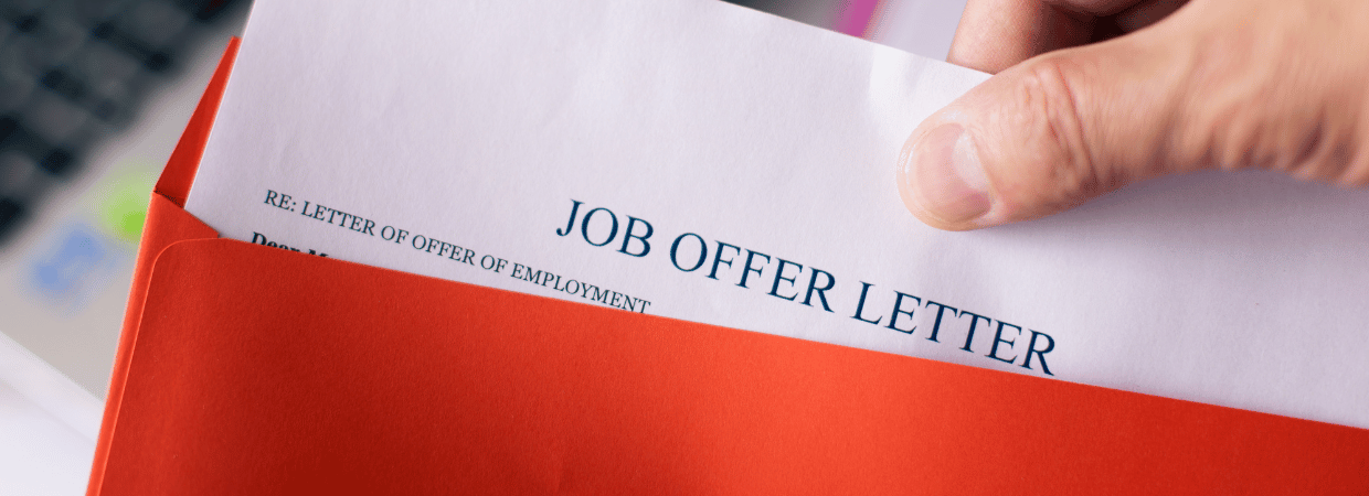 A picture of someone holding a job offer letter